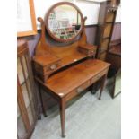 An early 20th century mahogany inlaid dressing table having swing mirror with trinket drawers to