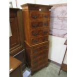 An early 20th century reproduction walnut veneered chest on chest with brush slideDimensions as