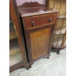 An early 20th century mahogany cabinet having single drawer above cupboard door