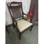 An early 20th century mahogany inlaid nursing elbow chair