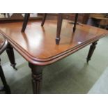 A Victorian mahogany wind out table with one centre leaf