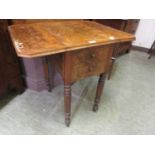 A Victorian walnut drop leaf work table having two drawers