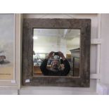 A driftwood framed wall mirror