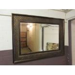 A modern ornate framed bevel glass mirror