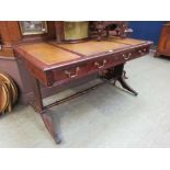 A Regency style mahogany desk having tooled leather inserts over drawers
