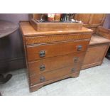 A mid-20th century oak veneered chest of three long drawers