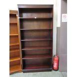 A modern open mahogany bookcase with adjustable shelving