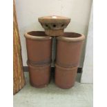 Four terracotta chimney pots along with one top