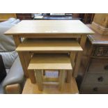 A nest of three modern oak occasional tables