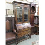 An early 20th century oak bureau bookcase having a pair of leaded glazed doors to top, the base