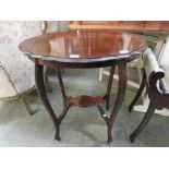 A mid-20th century oval topped occasional table with under tier