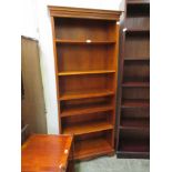 A modern cherrywood open bookcase with adjustable shelving
