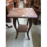 A mid-20th century occasional table with a carved leaf design and under tierNo apparent damage.