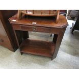 A mid-20th century oak side table with small drawer and under tier