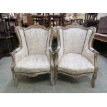 A pair of 18th century style gilt painted wing armchairs