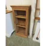 A pine open bookcase with adjustable shelves