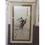 A framed and glazed oriental needlework on silk of lady on clouds