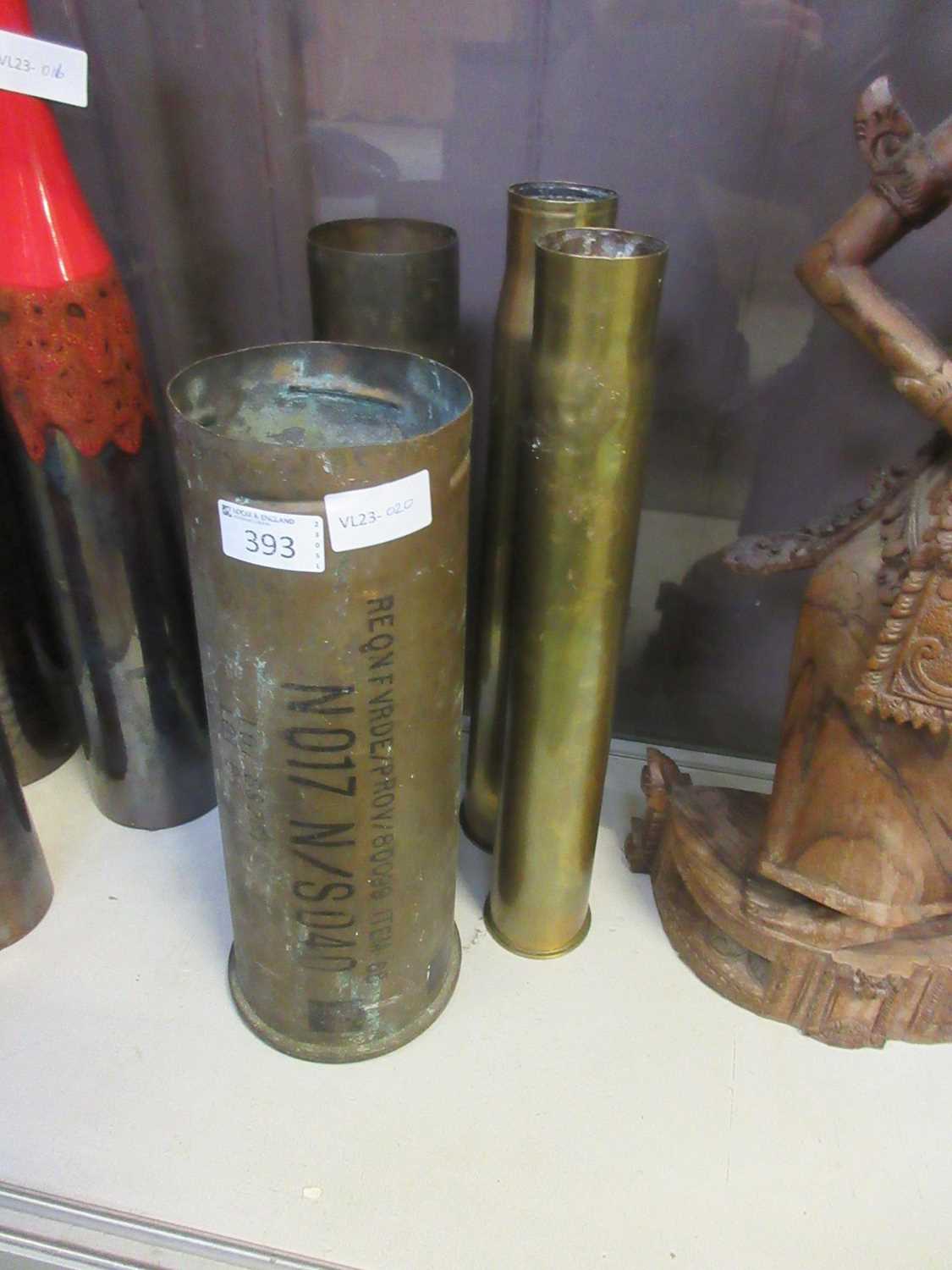 A collection of four brass shell cases