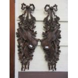 A pair of wood effect moulded plaques after Grinling Gibbons