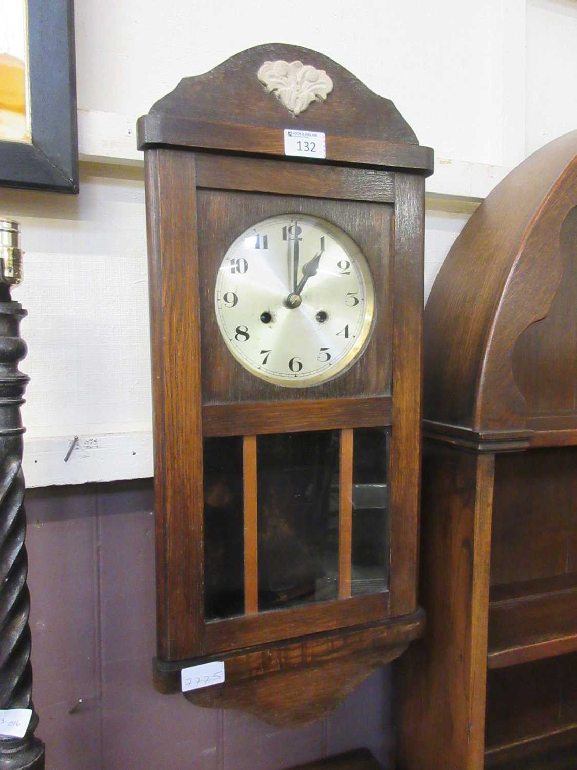 An early 20th century oak cased drop dial wall clock