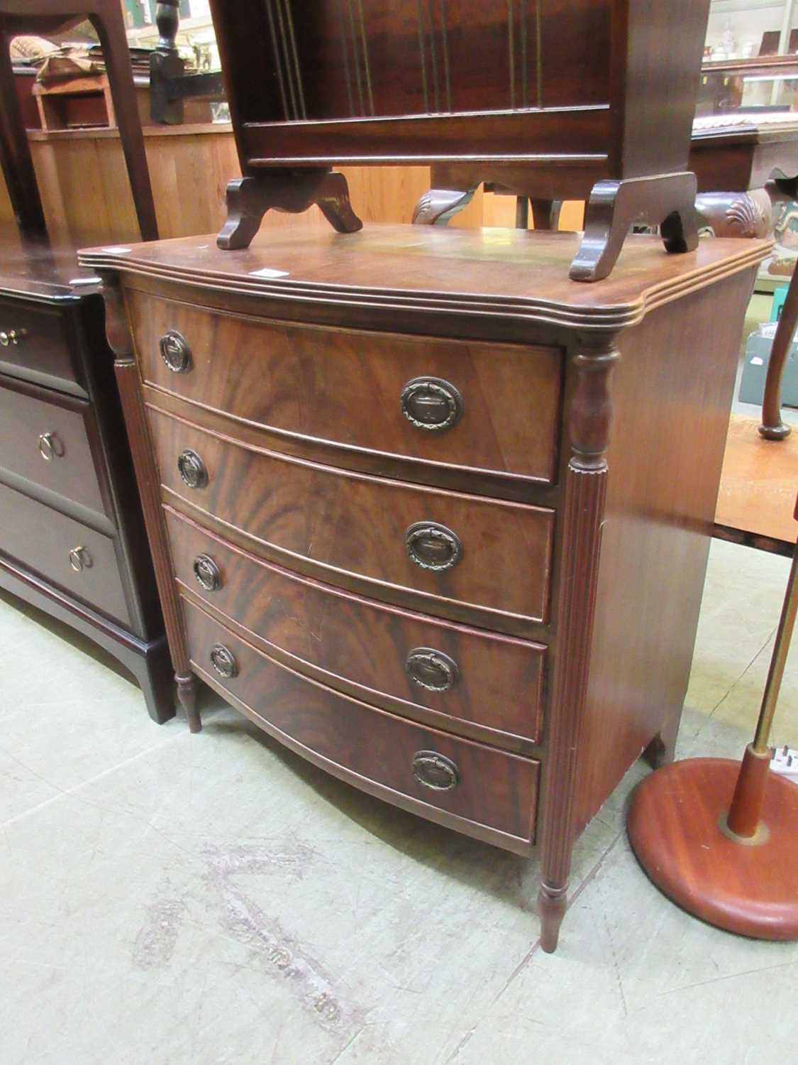 A reproduction framed mahogany bow fronted chest of four drawers