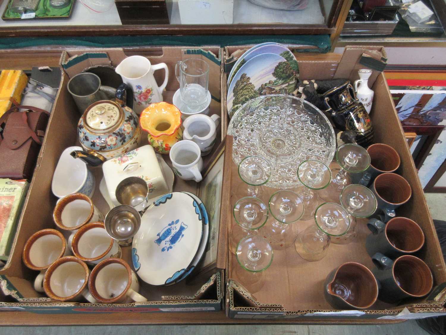 Two trays of ceramic and glassware to include mugs, teapot, drinking vessels, etc