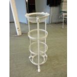 A white painted metalwork four tier vegetable stand