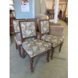 A set of four 19th century oak framed dining chairs upholstered in a floral pattern fabric