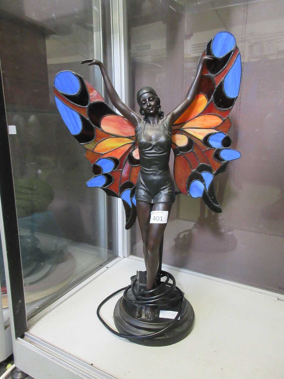 A reproduction Tiffany style lamp in the form of Art Deco lady with coloured glass wings