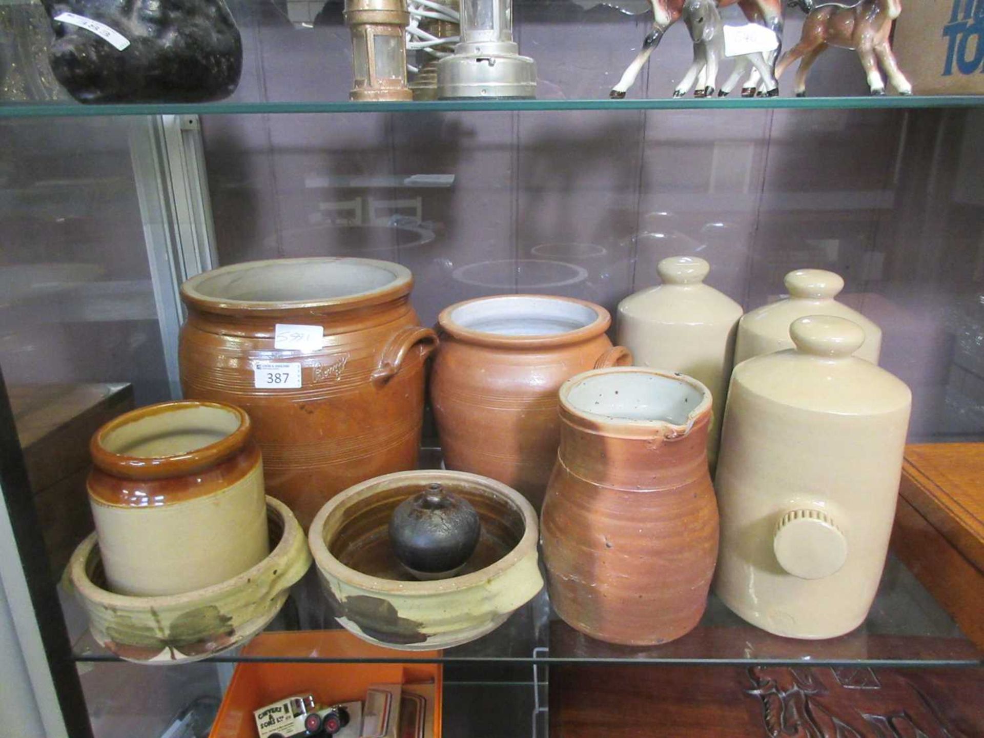 A selection of salt glazed vessels to include storage jars and hot water bottles