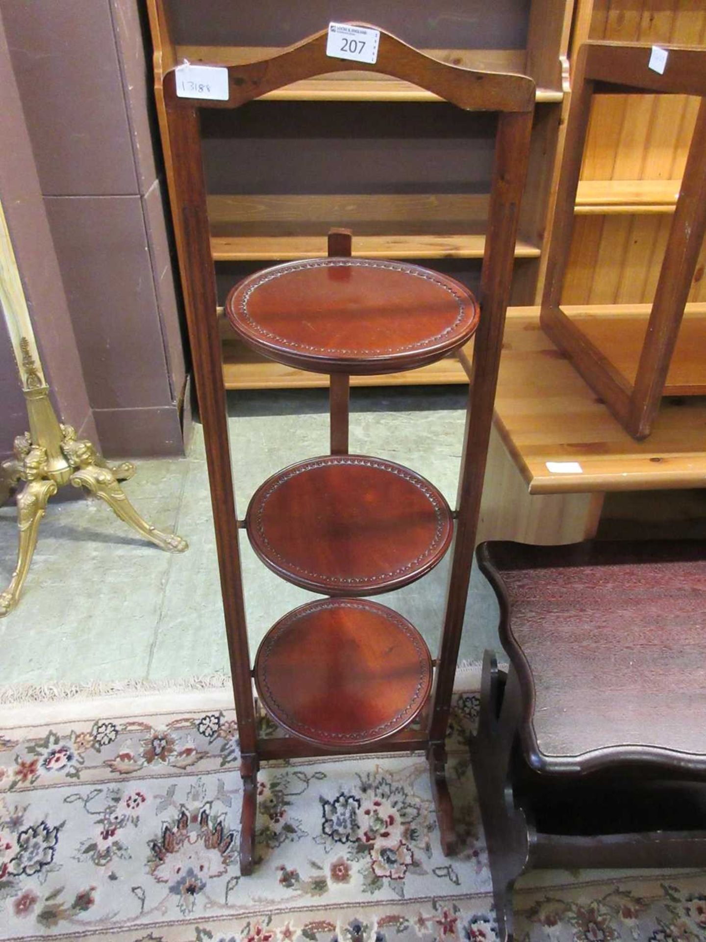 A reproduction mahogany folding cake stand