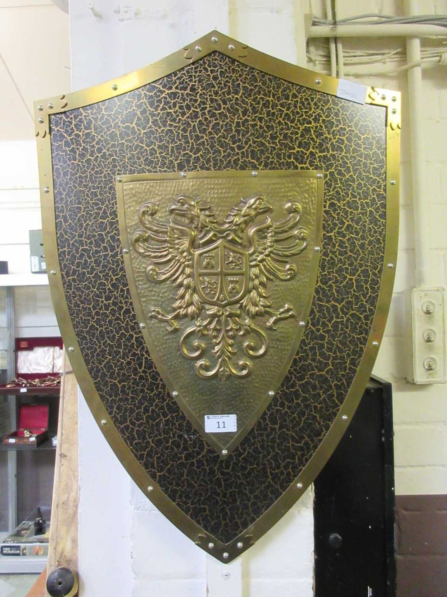 An embossed brass effect shield