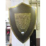 An embossed brass effect shield