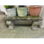 A composite stone garden bench