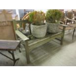 A weathered teak garden bench