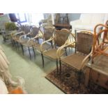 A set of six metal framed and wicker seated and backed garden armchairs