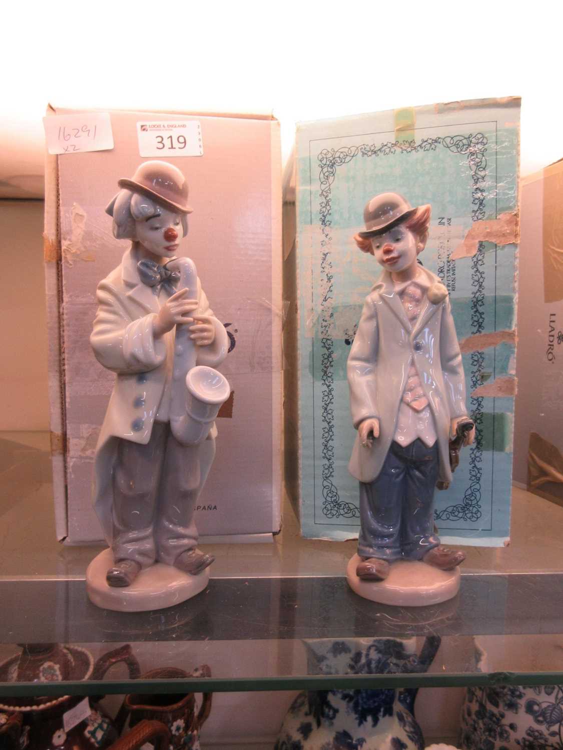 Two boxed Lladro figurines of clowns with musical instruments