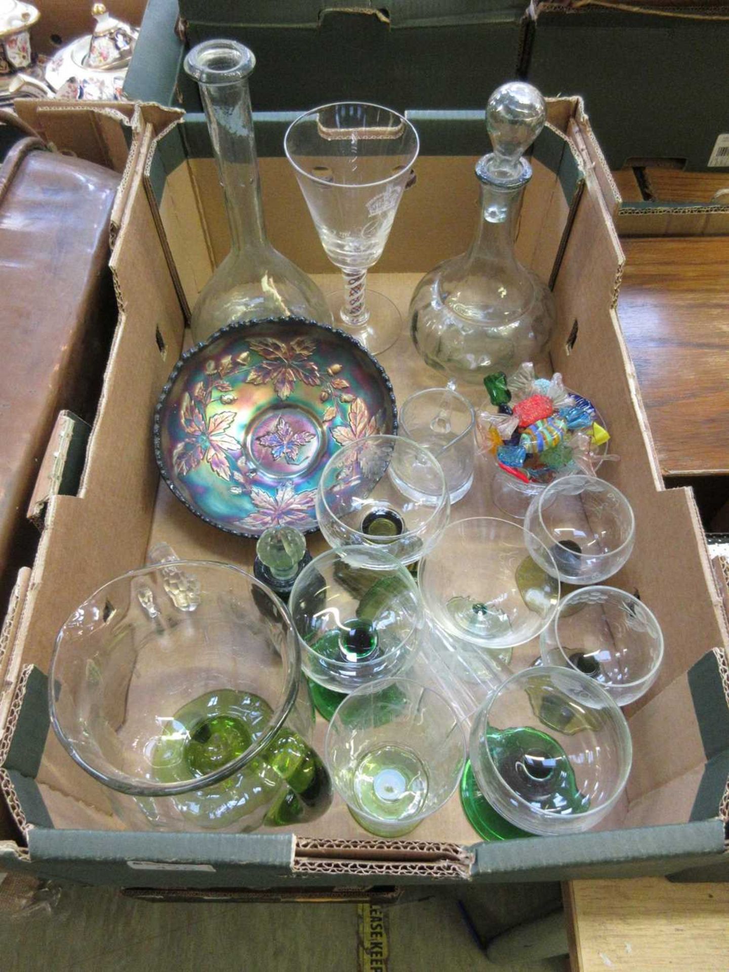 A tray of glassware to include green stemmed glasses, decanters, etc