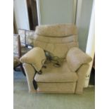 An electric rise and recline chair upholstered in a cut brown fabric