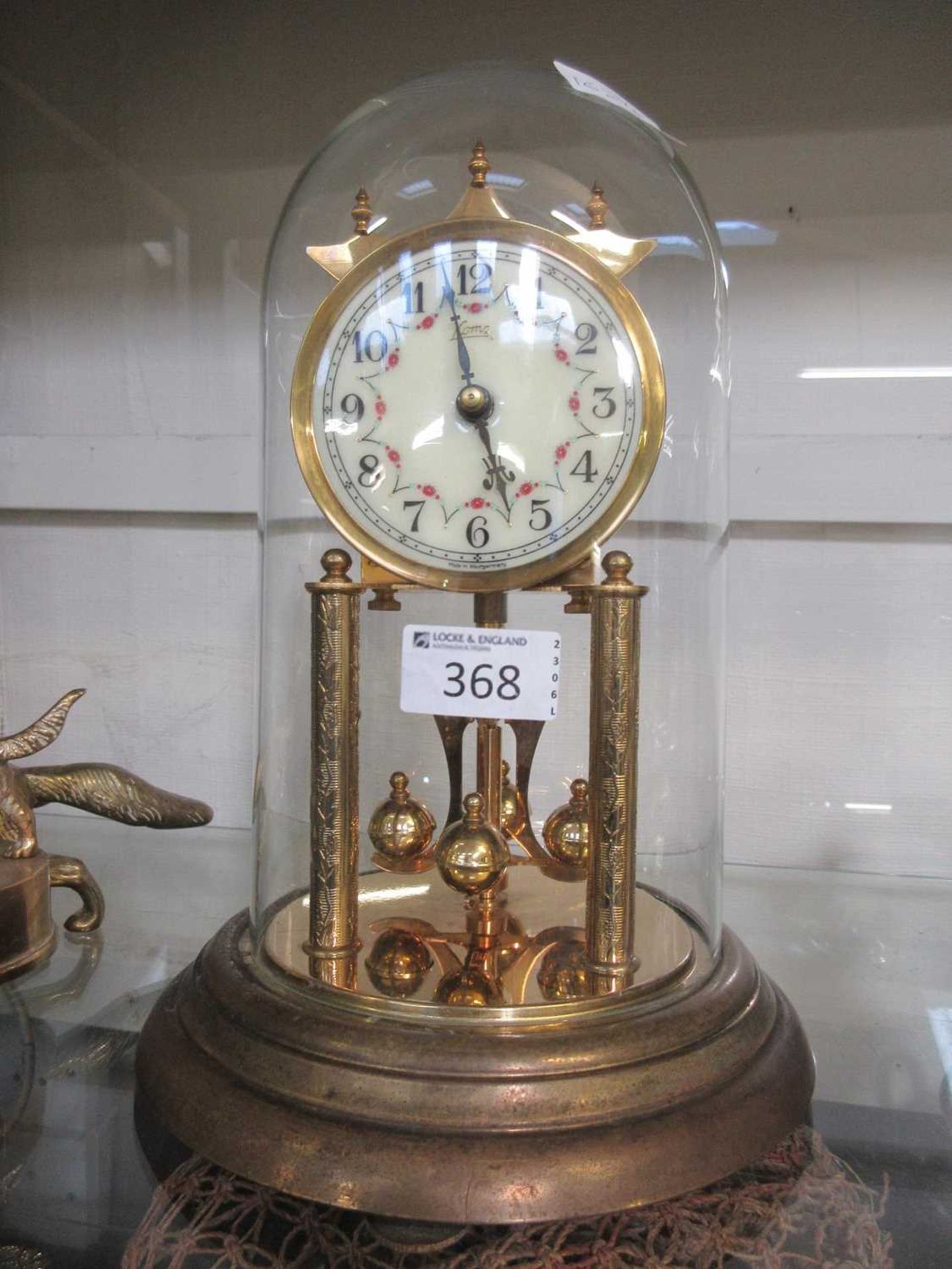 A glass cased anniversary clock