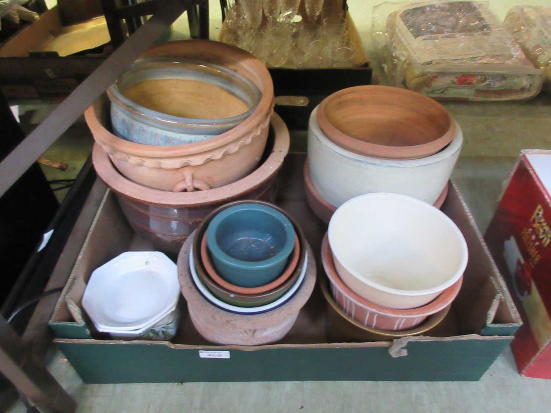 A tray containing a quantity of ceramic and terracotta garden pots