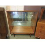 A mid-20th century teak bookcase with glazed sliding doors