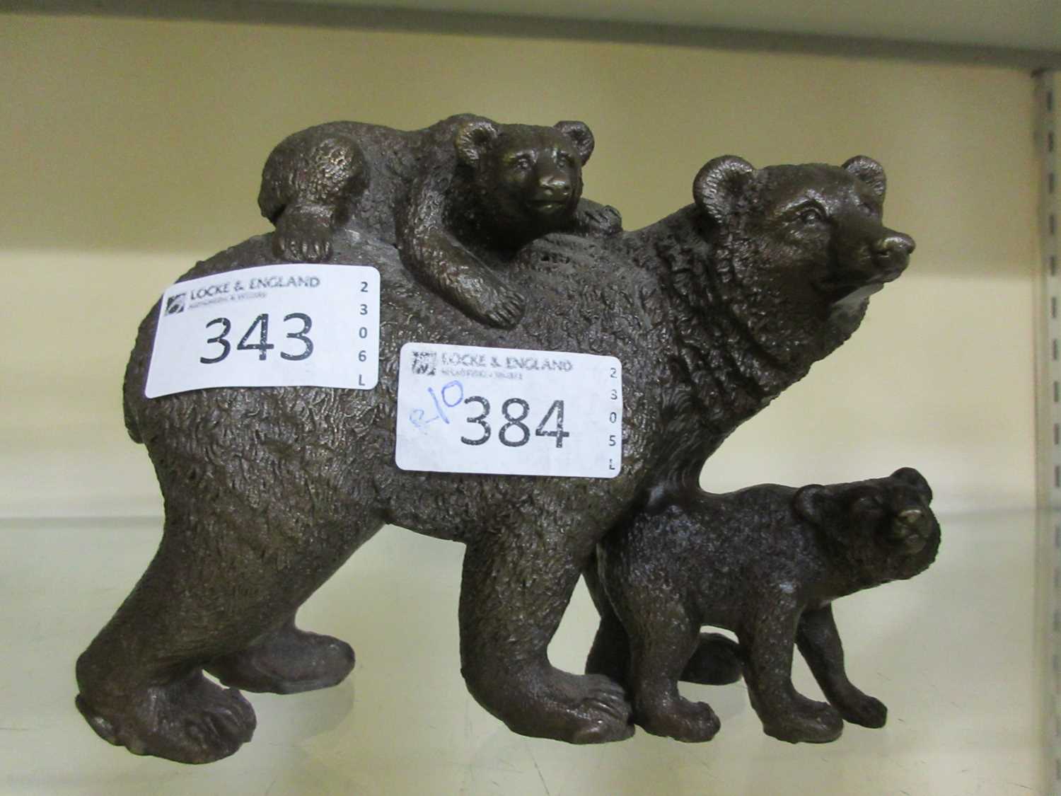 A cast metal figure of bear with cubs