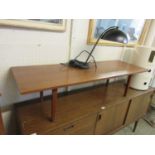 A mid-20th century teak veneered coffee table