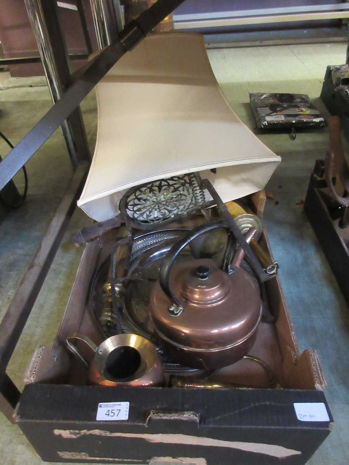 A tray containing an assortment of metalware to include copper kettle, plated tray, trivets, etc