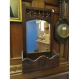 An early 20th century walnut wall hanging mirror with glove box
