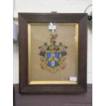 An oak framed and glazed heraldic shield