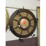 A wall hanging ship wheel style rack and mirror