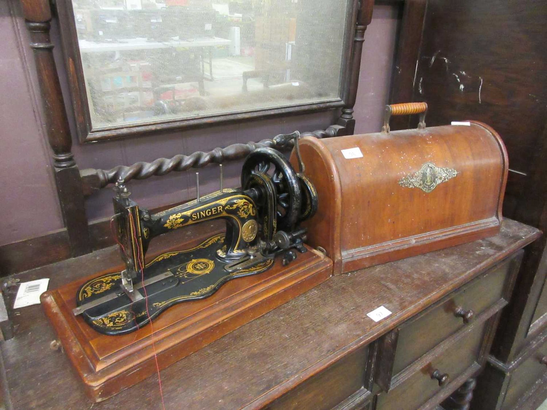 A dome cased Singer manual sewing machine