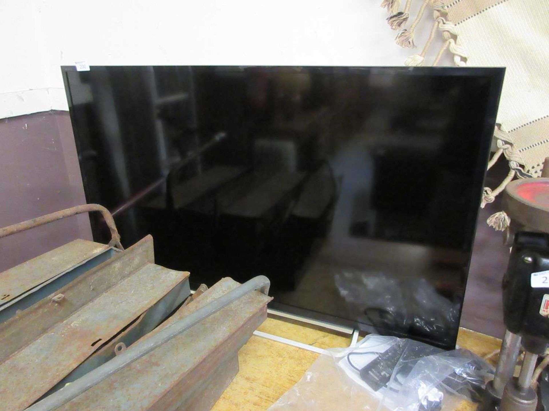 A Sony Bravia flat screen TV with remote